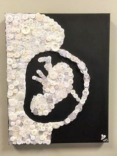 a black and white painting with buttons on it