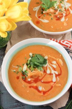 two bowls filled with soup and garnished with cilantro