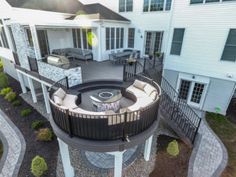 an aerial view of a house with a fire pit in the center and patio area