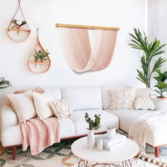 a living room filled with furniture and lots of pictures on the wall above it's coffee table