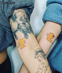 two people with matching tattoos on their arms