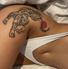 a woman with a tiger tattoo on her stomach