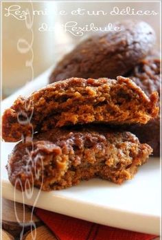 two cookies are stacked on top of each other in front of a glass of milk