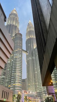 some very tall buildings in the city at night