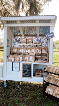 an outdoor food stand with boxes on it