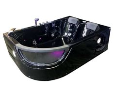 a large black bath tub sitting on top of a white floor