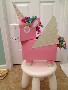 a pink toy horse sitting on top of a white toilet in front of a door