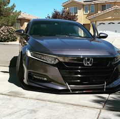 a black car parked in front of a house