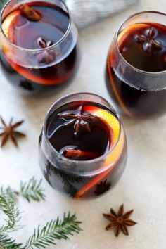 two glasses filled with liquid sitting on top of a table