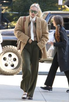 a woman walking down the street with her hands in her pockets