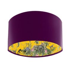 a purple and yellow lamp shade with an image of dinosaurs in the jungle on it