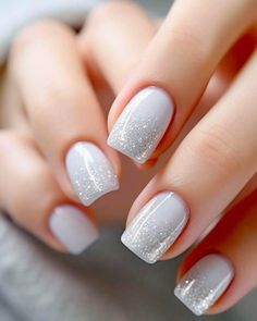 These nails showcase an elegant ombré design transitioning from a soft white base to a sparkling silver glitter tip. The square shape adds a modern and polished touch, perfect for a chic and understated look.  #OmbréNails #MinimalGlam #SparkleElegance Nails White Sparkle Glitter, Frosty Nail Designs, White Gel Nails With Glitter, Icy Winter Nails, Short Christmas Gel Nails, White Snow Nails, Glittery White Nails, Icy Nails Winter