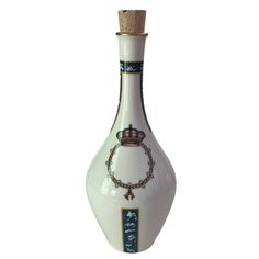 a white vase with a crown on it