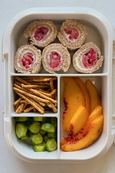 a lunch box filled with fruit and crackers