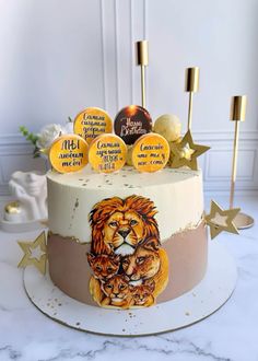 a cake decorated with an image of a lion and some gold stars on top of it