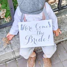 "This sweet \"Here Comes The Bride\" sign is the perfect accessory for your little flower girl or ring bearer to carry down the aisle! They can wear this draped around their neck or you can attach it to a wagon if your little attendant is still pretty little (you might want to select our \"separate ties\" option for attaching it to a wagon). For over 10 years people have trusted Ritzy Rose on Etsy with their sign needs. BENEFITS * lightweight versatile design * easily readable and prints exactly Wedding Wagons For Flower Girl Tulle, Ring Bearer Sign, Funny Wedding Signs, Wedding Flags, Ring Bearer Signs, Whimsical Ring, Flower Girl Signs, Bride Sign, Banner Size