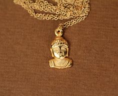 Buddha necklace - yoga necklace - gold buddha head necklace - a precious little golden buddha hanging from a 14k gold vermeil chainThis dainty little 22k gold plated bronze buddha hangs from a 16 inch 14k gold vermeil chain.  Please feel free to select a different length chain!Looking for other charm necklaces?https://www.etsy.com/shop/BubuRuby?section_id=12318467♥ This gem will arrive happily in a gift pouch or boxReady to ship! Gold Pendant Necklace For Meditation, Handmade Gold Necklaces For Meditation, Handmade Spiritual Gold Charm Necklaces, Gold Buddha, Golden Buddha, Little Buddha, Yoga Necklace, Buddha Necklace, Head Necklace