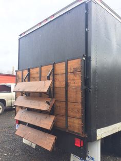 the back end of a trailer loaded with wooden boards