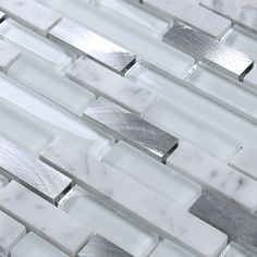 white marble and metal mosaic tiles with silver lines on the backsplash, closeup