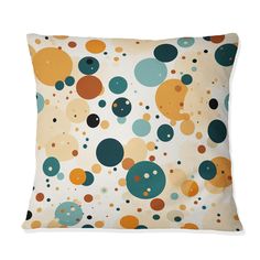 a pillow with circles on it in blue, yellow and orange colors is featured against a white background