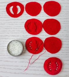 red felt circles with white thread next to it and a bowl of rice on the table