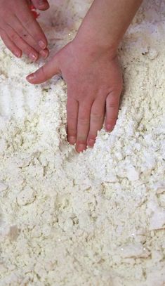 two hands on top of a pile of flour