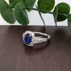 This ring design is a tried and tested NNJ Designs favorite! Featuring a gorgeous Ceylon blue sapphire with a stunning diamond halo and accented shank that elevates this ring to a gorgeous statement piece, all set in solid 14k gold! This ring is made with solid 14K Gold and naturally Earth-mined SI / G-H diamonds. As listed, this ring is ready to ship. If you're interested in purchasing this setting with a different center stone please message us! Blue Cluster Diamond Ring With Halo Setting, Blue Sapphire Ring With Halo Cluster Setting, Blue Cluster Ring With Halo Setting In Cubic Zirconia, Blue Cubic Zirconia Wedding Ring With Halo Setting, Blue Cubic Zirconia Diamond Ring With Halo Design, Sapphire Halo Ring With Brilliant Cut Lab-created Sapphire, Blue Cubic Zirconia Cluster Ring With Halo Setting, Blue Moissanite Diamond Ring With Halo Setting, Blue Diamond Cluster Ring With Halo Design