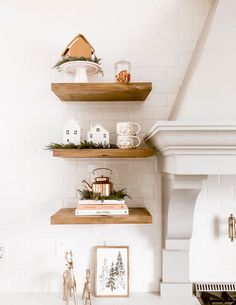 three wooden shelves with christmas decorations on them in a white kitchen, along with other decor items