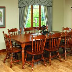 a dining room table and chairs with wooden floors