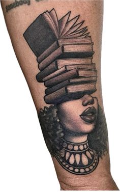 a woman's leg with books on her head