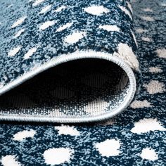 a blue rug with white dots on it