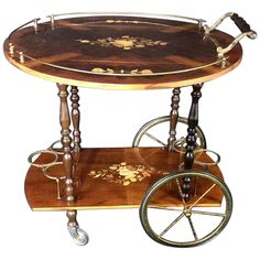 an antique wooden serving cart with wheels