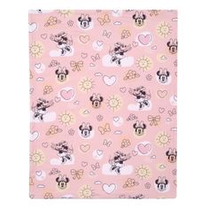 a pink blanket with mickey and minnie mouses all over the print, on top of it