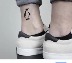 a person with a penguin tattoo on their left foot, and an image of a penguin behind them