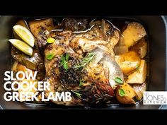 slow cooker greek lamb with potatoes and lemons in a roasting pan on the stove