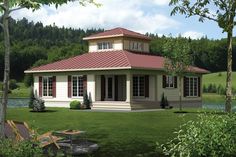 a small house sitting on top of a lush green field next to a lake and forest