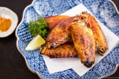 fried chicken wings on a blue and white plate