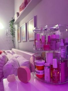 there are many different types of beauty products on the table in front of the bed