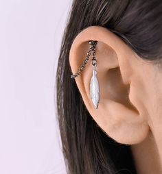 a woman's ear with a chain attached to it