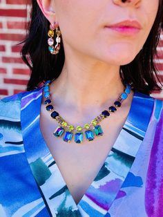 This Nailah Necklace is a work of art! With an antique gold plated brass base metal, 17" length and a 3" extension, you'll be getting compliments like it's no one's business. The high quality crystals will send you and your neckline to a new realm of sparkle. -FINAL SALE- Multi-stone Metal Jewelry For Party, Multicolor Brass Elegant Necklaces, Elegant Multicolor Brass Necklaces, Costume Jewelry Brass Necklaces With Jewels, Gold Crystal Necklace With Gemstone Accents, Costume Jewelry Brass Necklace With Jewels, Brass Jewel Costume Necklace, Brass Costume Jewelry Necklaces With Jewels, Brass Costume Jewelry Necklace With Jewels