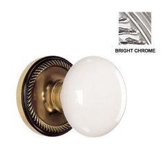 the bright chrome door knob is shown with an ornate design and white glass ball on it