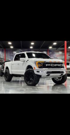 a white truck is parked in a garage