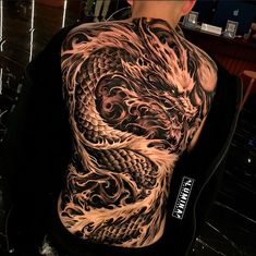 a man with a dragon tattoo on his back