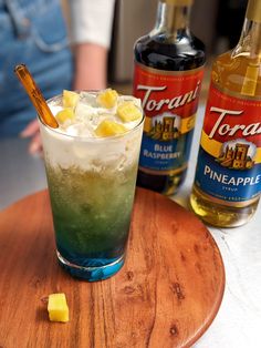 two bottles of torani blue raspberry and pineapple liquer