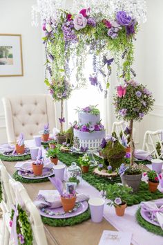 the table is set with purple and green decorations