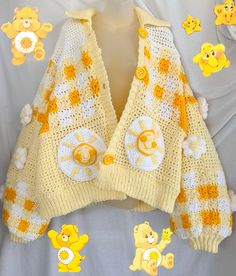 a yellow and white knitted sweater with teddy bears on it