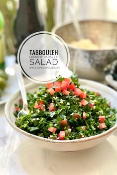 tabbouleh salad in a white bowl with a spoon on the side and a sign that reads tabbouleh salad