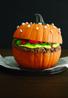 a pumpkin shaped like a hamburger sitting on top of a plate