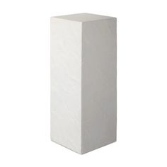 a tall white vase sitting on top of a table