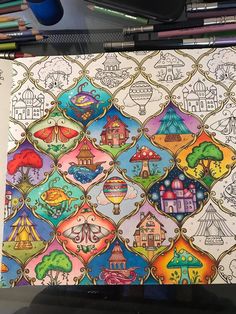 this is an image of a coloring book with many different designs on it and some colored pencils next to it